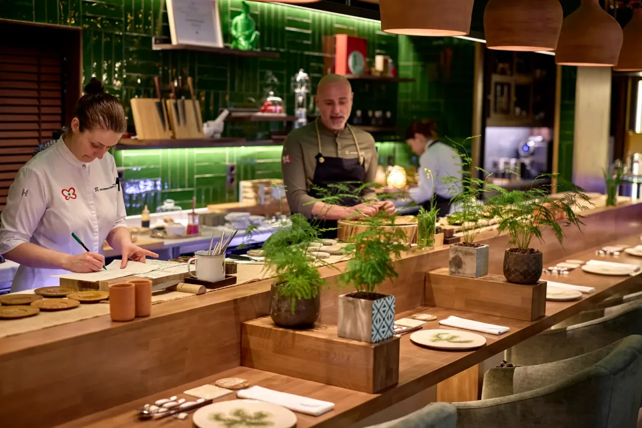 El equipo de cocina trabajando en el pase de El Invernadero